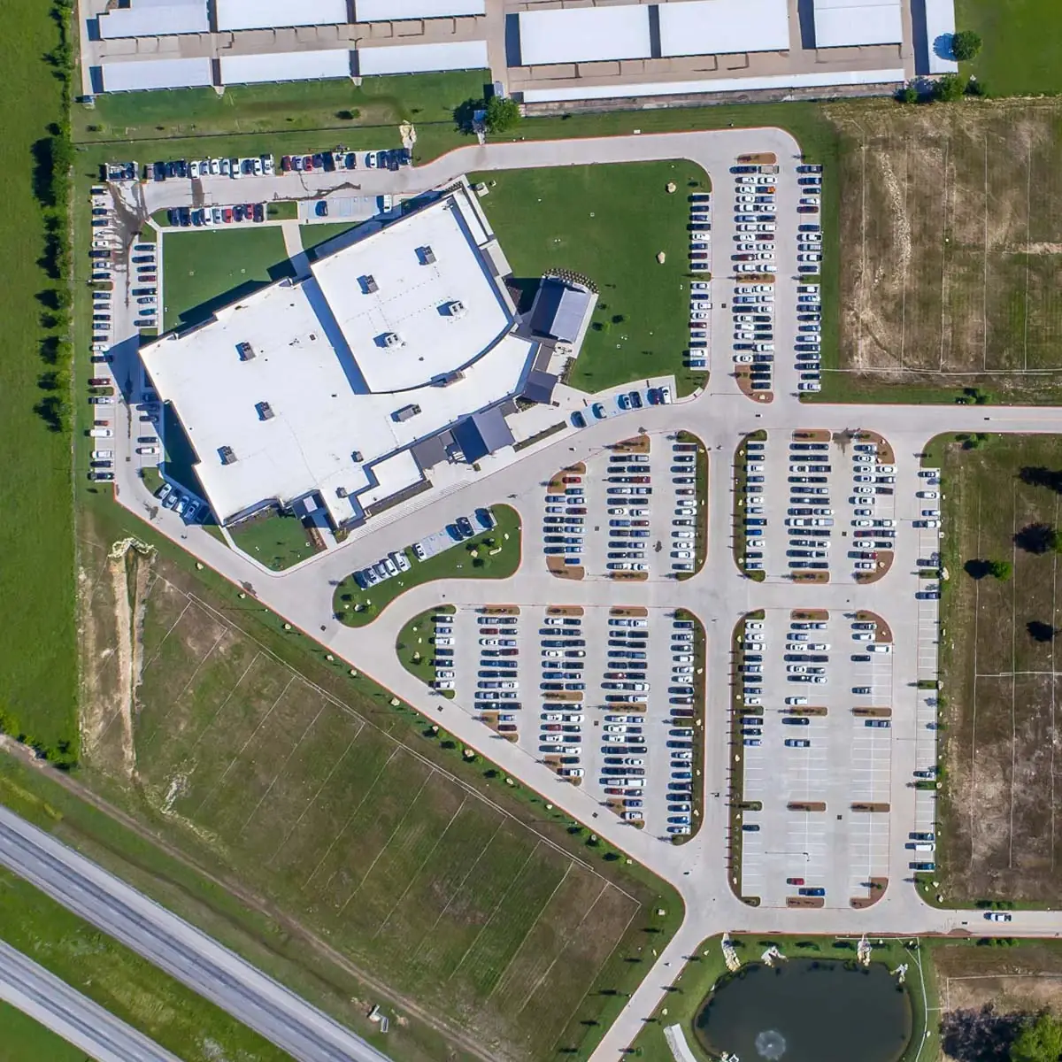 Aerial view of a completed church campus and parking