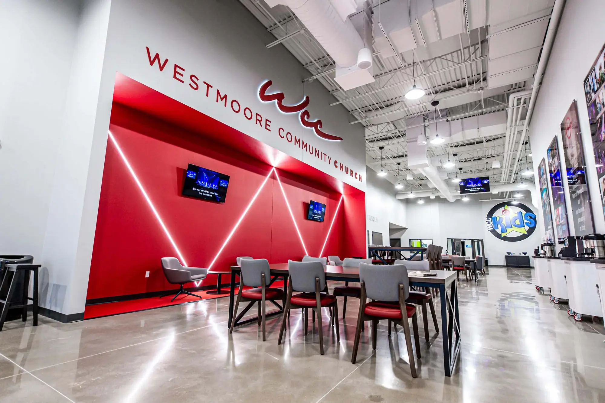 Red-walled café and lounge seating inside Westmoore Community Church